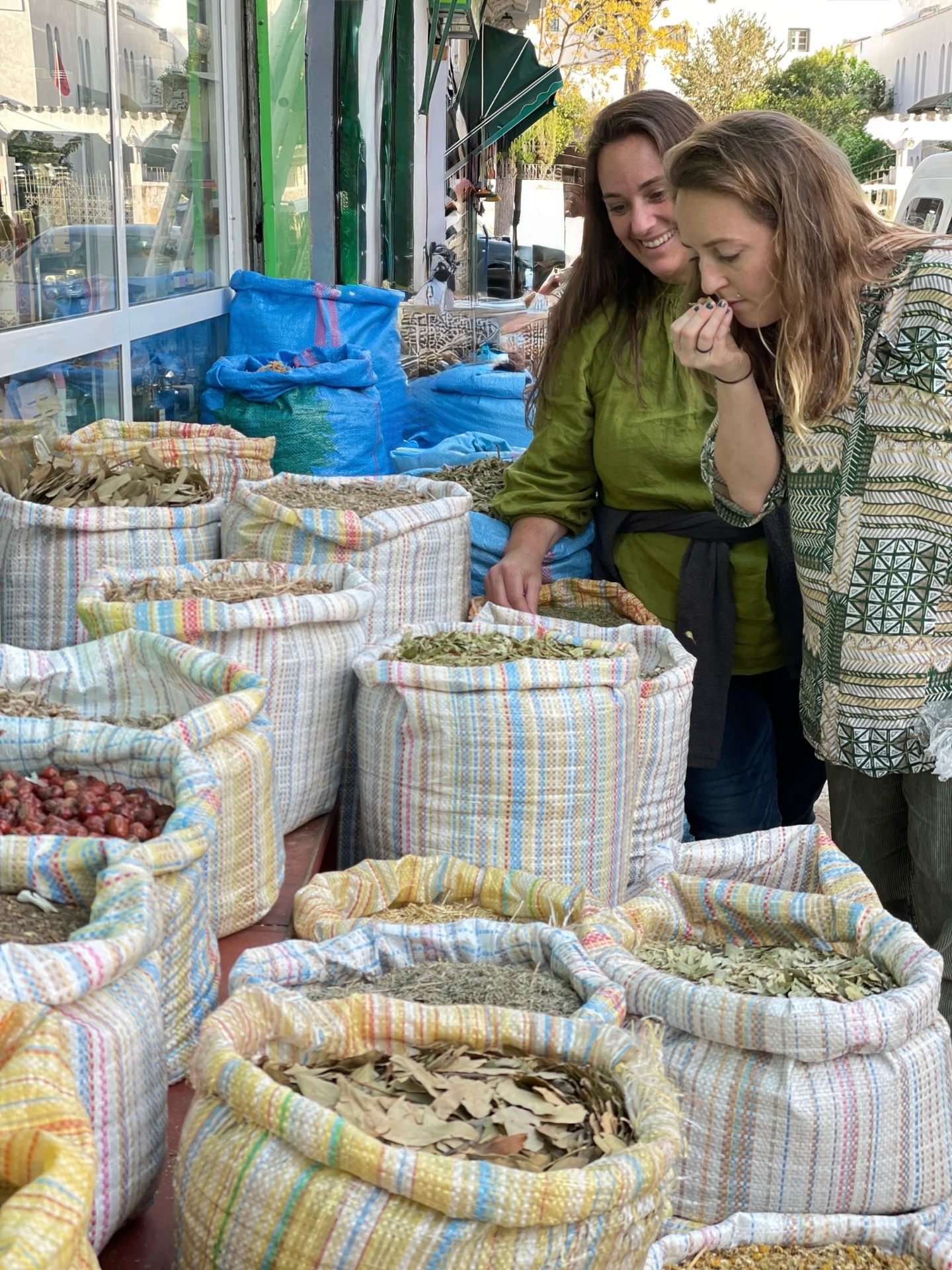 June and Tulsi exploring herbs and spices at a market